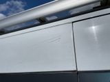 a white van with a metal roof rack on it ' s side