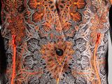 an orange and black vest with a floral design on it