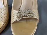 a close up of a pair of shoes with a bow on them