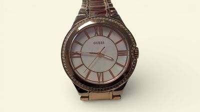 a close up of a wrist watch on a white surface