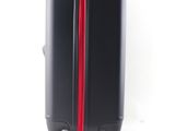 a black suitcase with a red stripe on it