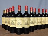 several bottles of wine are lined up on a table