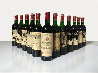 several bottles of wine are lined up in a row on a table