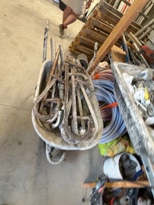a man that is standing next to a pile of tools