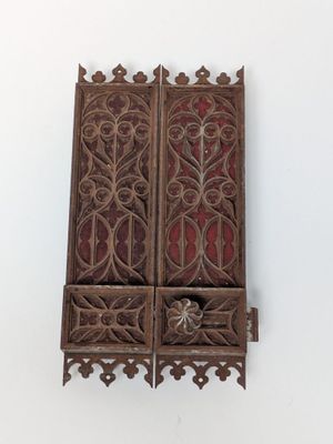 pair of antique carved wood window shutters with red glass panels