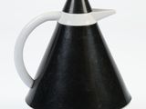 a black and white pitcher with a white handle