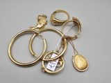several gold rings and a ring with a heart on it