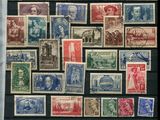 a collection of stamps from different countries on display in a glass case
