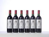 four bottles of wine are lined up on a table