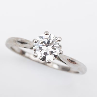 a close up of a diamond ring on a white background
