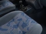 a picture of the interior of a car with a blue seat cover