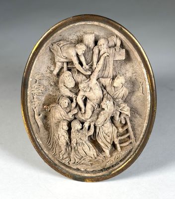 une assiette en argent ornée d'un relief représentant un groupe de personnes