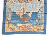 an image of a blue and white square scarf with a picture of a ship