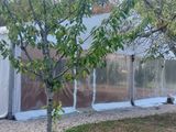 a white tent that is next to some trees