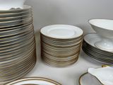 a lot of plates and bowls on the table