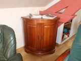 a small corner cabinet in the corner of a living room