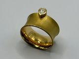 a close up of a gold ring with a diamond on it