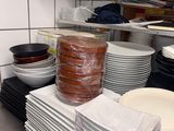 a stack of plates and bowls on a counter in a kitchen