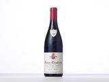 a bottle of red wine sitting on top of a table