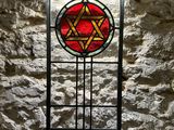a stained glass window with a star of david on it