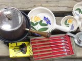 many bowls and pans that are hanging on the wall