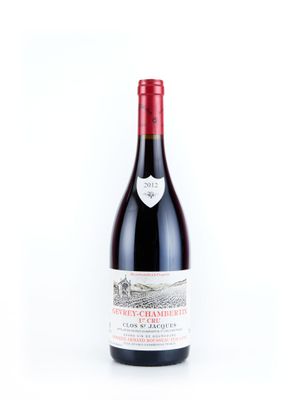 la bouteille de vin rouge est posée sur une surface blanche