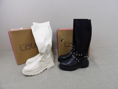 two pairs of black and white boots sitting next to each other