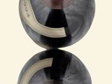 two bottles of wine sitting on top of each other