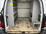 a white van with the door open and a table in the back