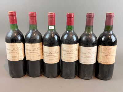 six bottles of wine lined up in a row on a table