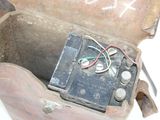 an old suitcase with a battery inside of it