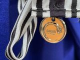 a medal that is attached to a blue and white bag