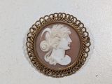 a close up of a picture of a woman ' s face in a broocher