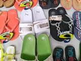 many pairs of flip flops laid out on a table