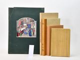 three books sitting on top of each other on a table