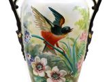 a vase with a bird painted on the side of it