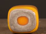 a yellow and gray object sitting on a wooden table
