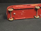 a red toy truck that is sitting on a black surface