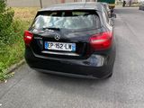 a black car that is parked on the side of the road