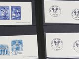 several stamps are displayed on a black surface with a black frame