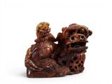 chinese carved figurine of a man and a woman sitting on a rock
