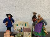 trois figurines assises sur une table