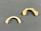 two pieces of metal are sitting on a table