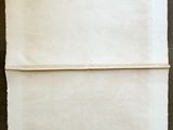 an old piece of paper sitting on top of a wooden table