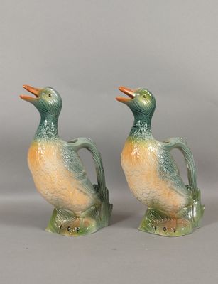 pair of green and orange duck figurines sitting on top of each other