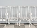three white metal chairs sitting next to each other on top of a checkered floor