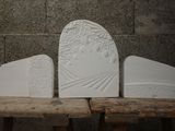 three pieces of white stone sitting on a wooden table