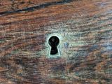 a wooden table with a key hole in it