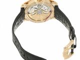 a close up of a watch with a black strap on a white background