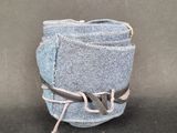a close up of a pair of jeans with a tie around it